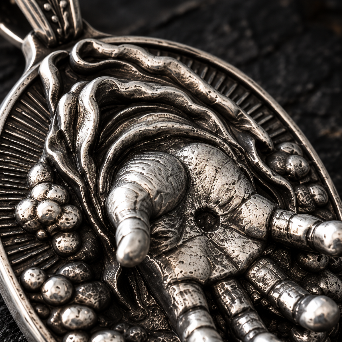 Close-up of the raised open hand on the silver Right Hand of God Pendant