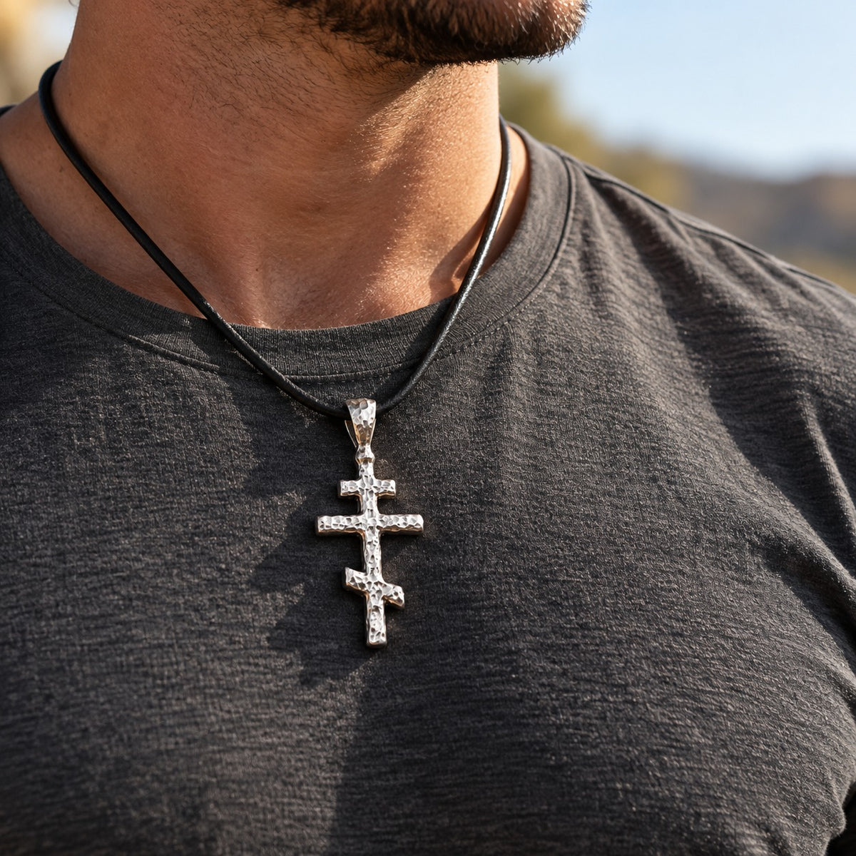 Man wearing the silver Orthodox Cross Pendant on a black leather cord