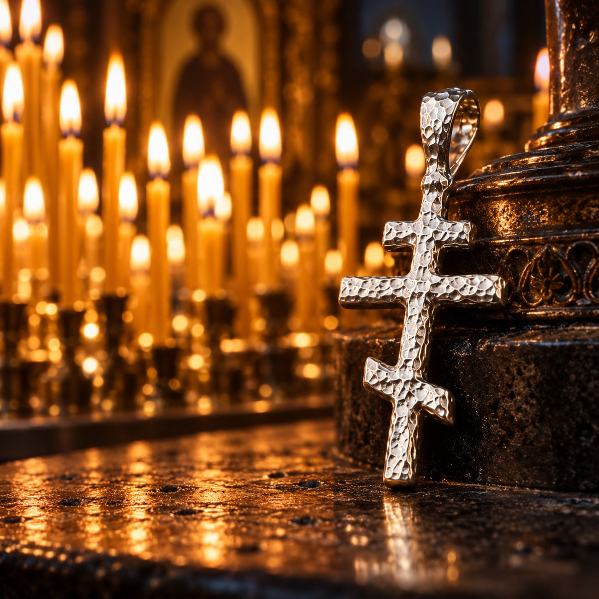 Silver Orthodox Cross Pendant among lit church candles