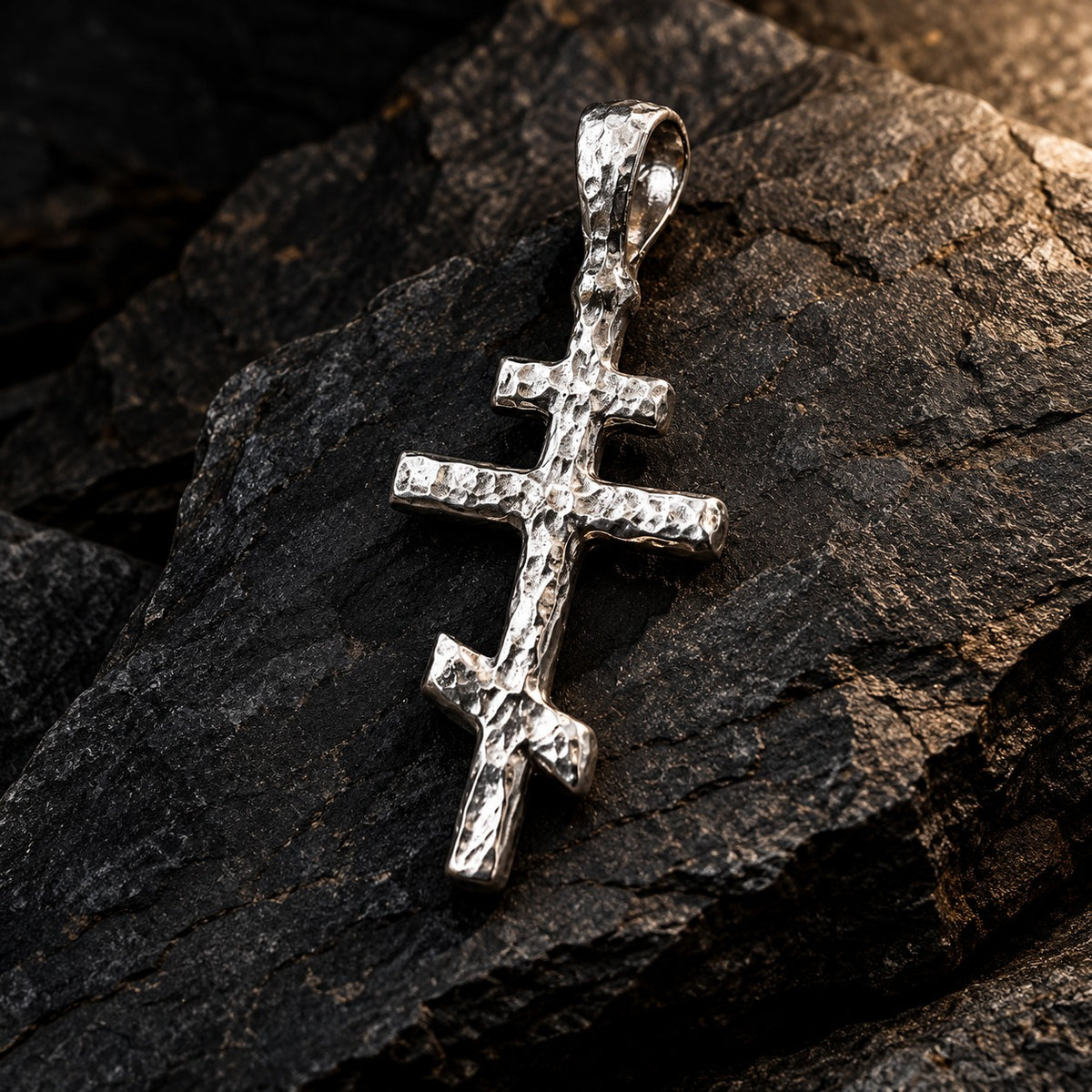 Hand-cast silver Orthodox cross pendant on dark slate