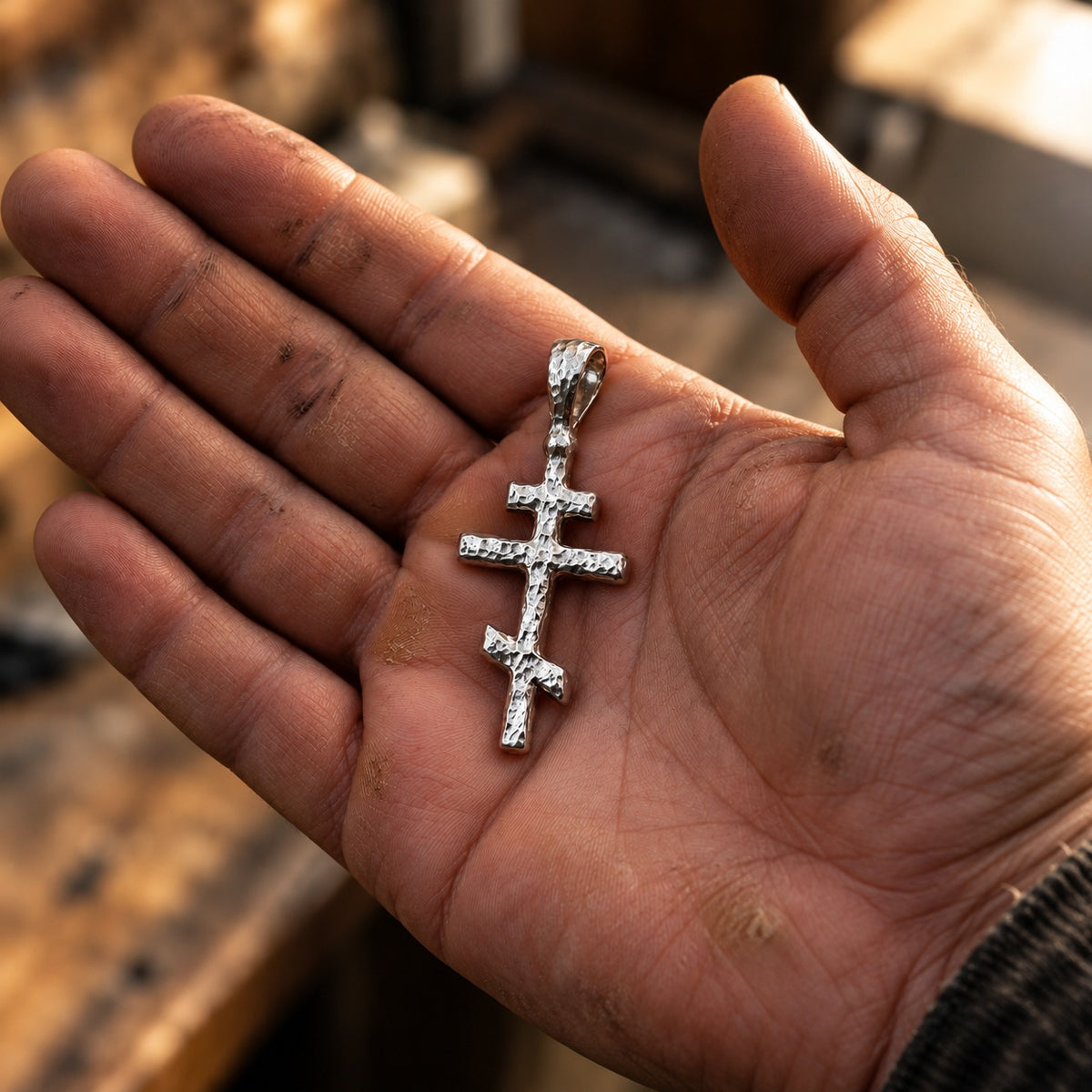 Silver Orthodox Cross Pendant held in an open palm to show size