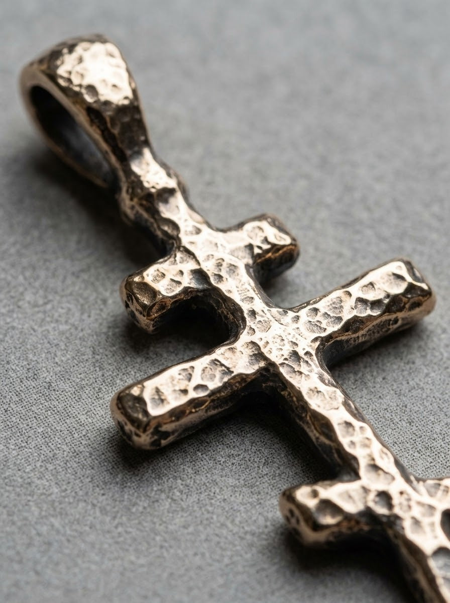Close-up of the bronze Orthodox Cross Pendant's hammered texture and bail